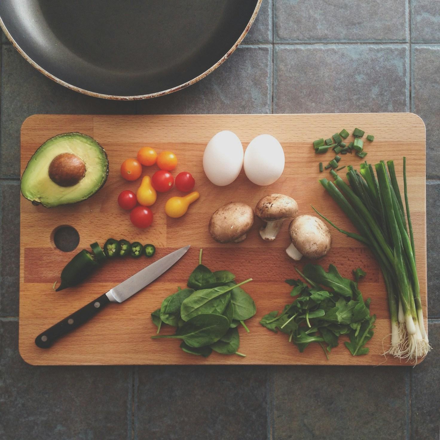 Community members collaborating in a modern kitchen space, sharing recipes and cooking techniques
